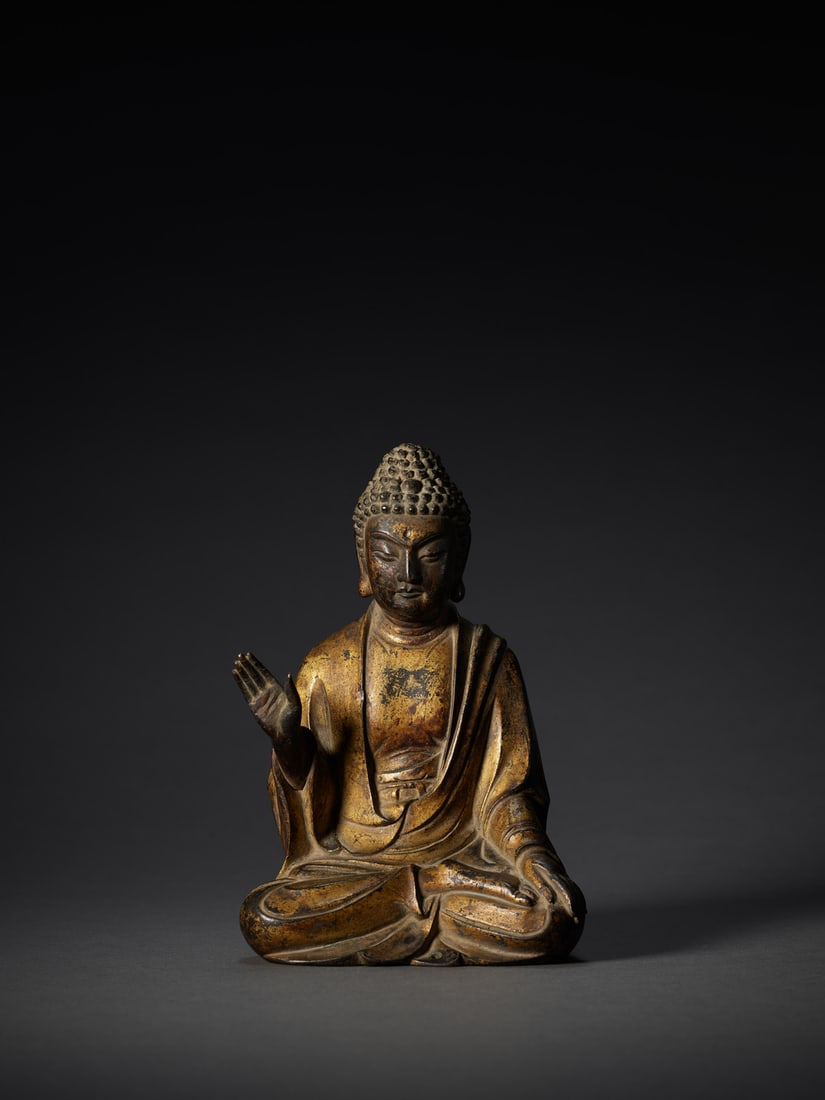 A GILT-BRONZE FIGURE OF A SEATED BUDDHA (1 of 1)