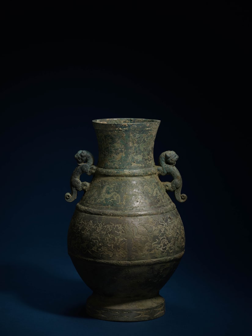 A BRONZE 'HUNTING SCENE AND DRAGON' VASE (1 of 2)