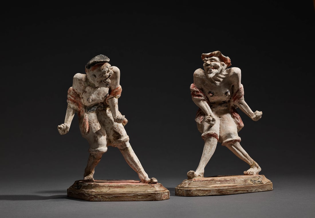 A PAIR OF PAINTED POTTERY FIGURES (1 of 1)