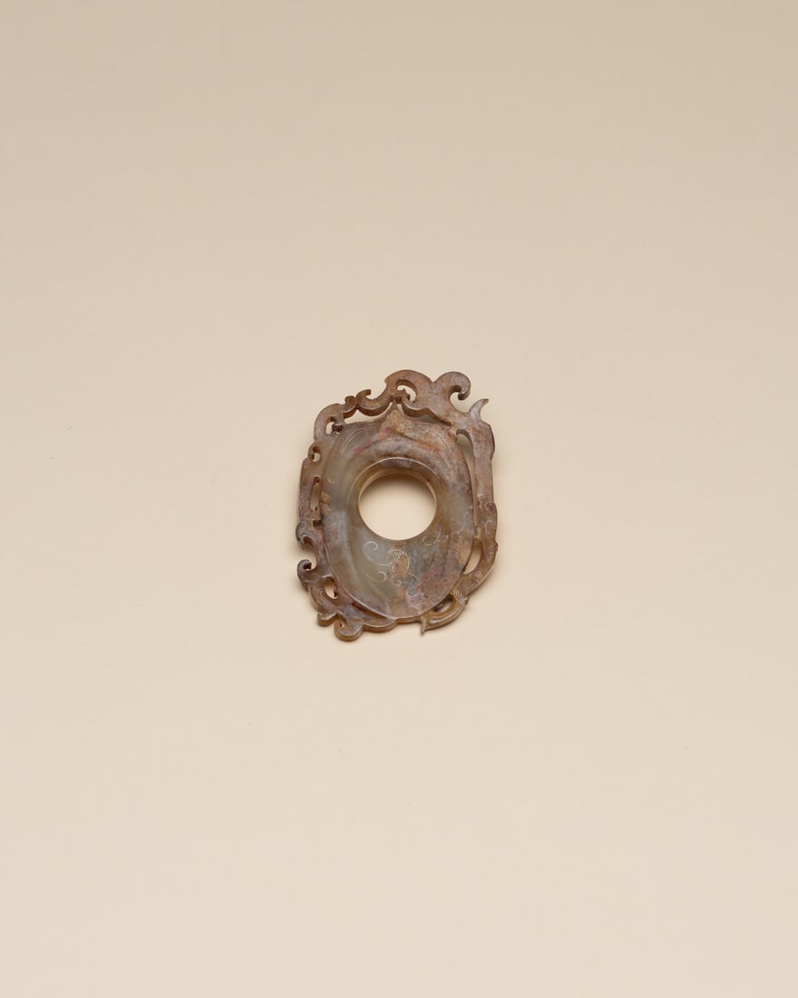 A WHITE JADE 'PHOENIX' PENDANT: 品名(title):漢 白玉出廓鳳紋韘形珮。年代(Age): HAN (206 B.C.-220 A.D.)。 尺寸:8.2 cm Height&#