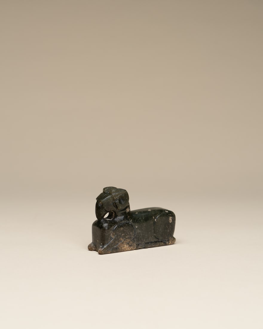 A CELADON JADE FIGURE OF A MYTHICAL BEAST (1 of 2)