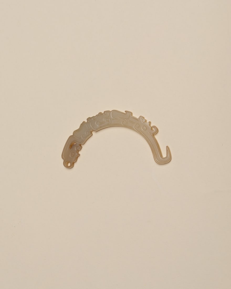 A JADE 'MASK' PENDANT, XI (1 of 2)
