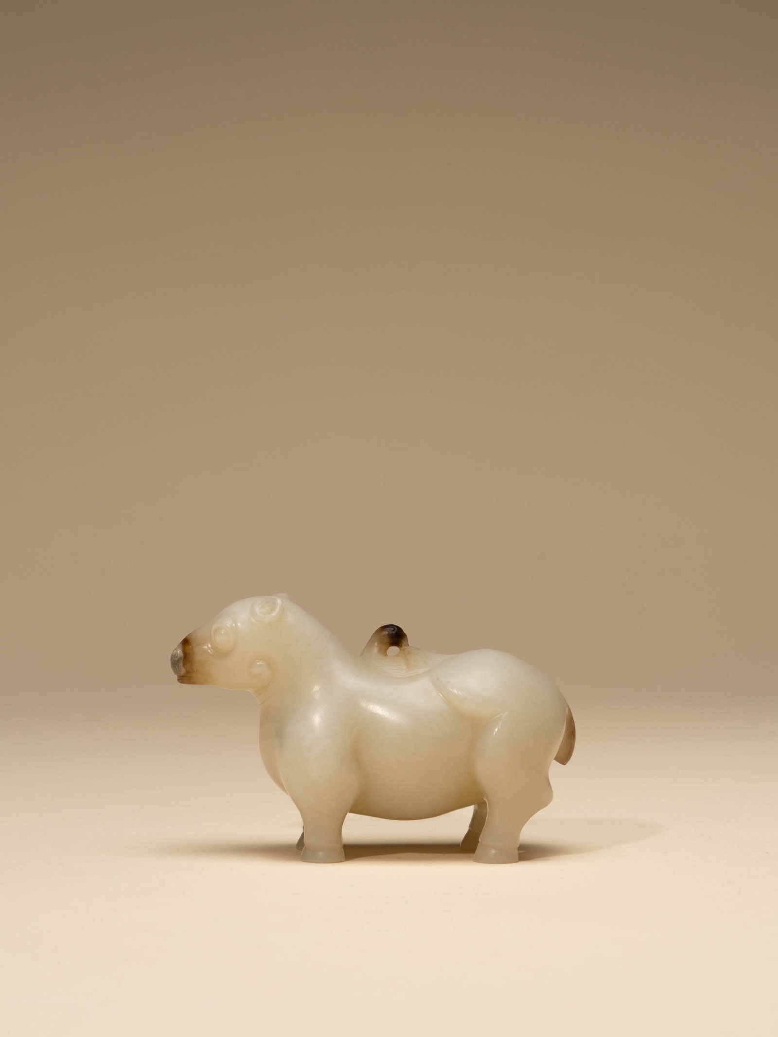 A WHITE JADE FIGURE OF A MYTHICAL BEAST (1 of 5)