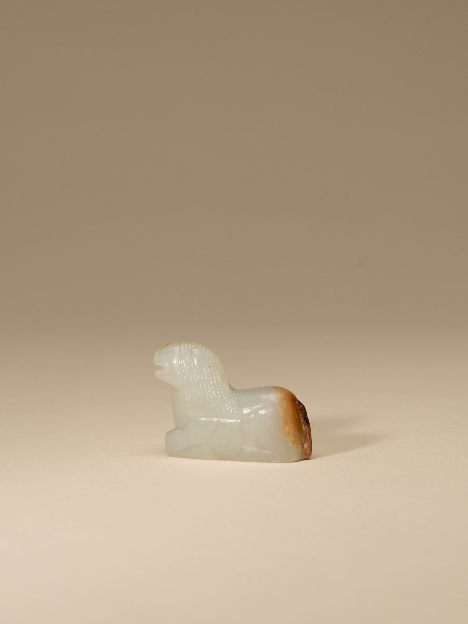A WHITE JADE FIGURE OF LION (1 of 4)