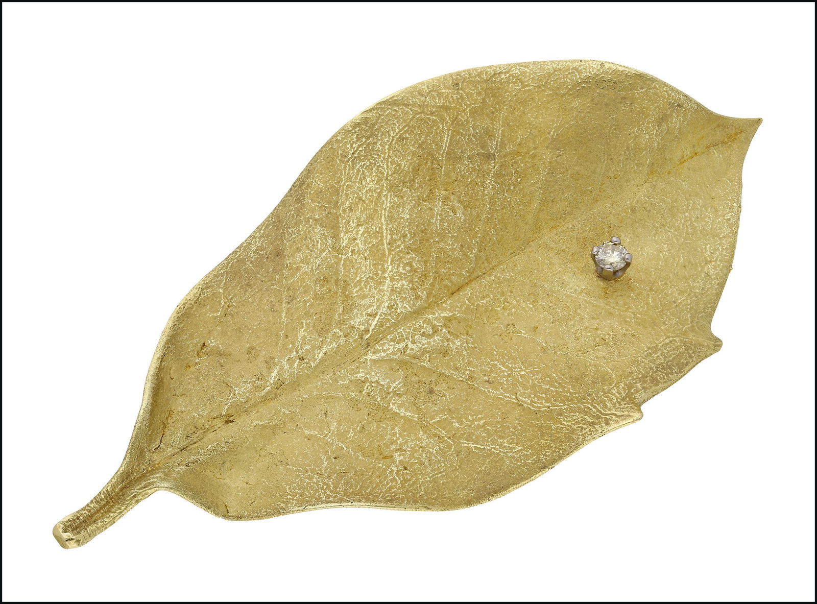 Jewellery: A gold and diamond holly leaf brooch, by Andrew Grima, the veined leaf with slightly brushed matt finish, set with a single brilliant-cut diamond highlight, in a raised four claw white precious metal