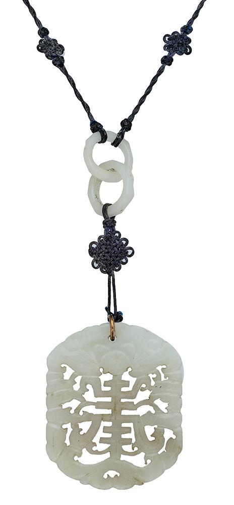 Jewellery: A jade pendant, the mutton fat jade carved and pierced decorated with the character 'Chou', for Longevity, on a woven necklace with interlocking faceted spacers, jade untested, pendant length 5.6cm. &
