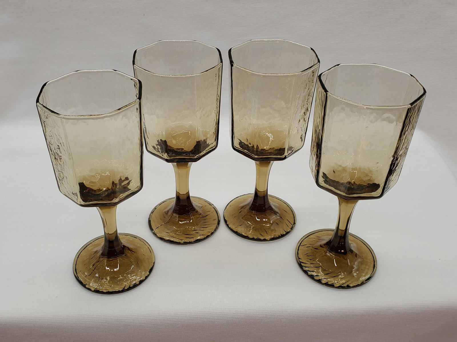 Smoked Footed Water Glasses: Vintage set of 4 mid-century smoke brown glass tumblers with a unique tapered base design. Nice quality hand feel with a good bottom-weighted heft. Measures 5 1/2" tall, 2 1/4" base diameter, and 2 1/