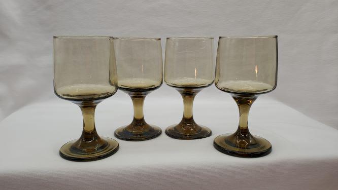 Smoked Stem Wine Glasses: Vintage set of 4 mid-century smoke brown wine glass with a unique pedestal base design. Nice quality hand feel with a good bottom-weighted heft. Measures 5" tall, 2.5" base diameter, and 2.25" rim dia