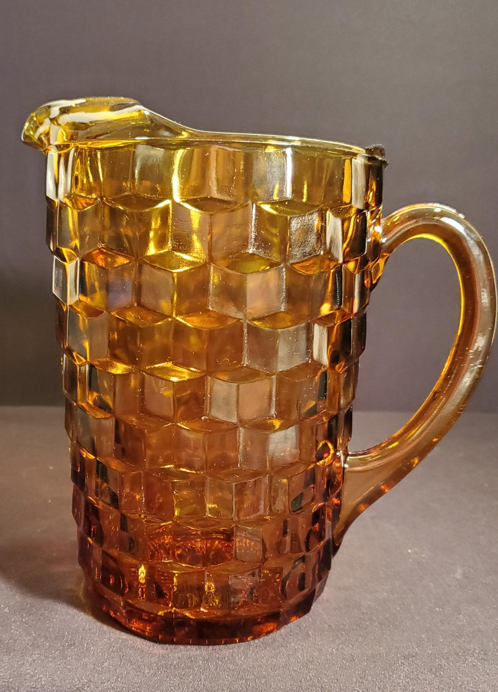 Amber Glass Pitcher: Heavy Amber Glass Pitcher with ice lip, three dimensional black pattern design, 9inch tall