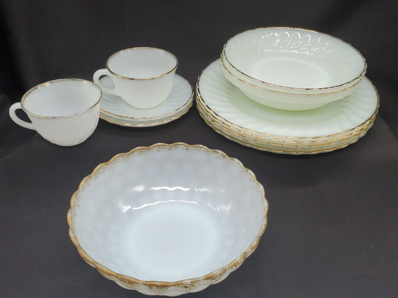Vintage Mid Century Anchor Hocking Dishware set: Vintage Mid Century Anchor Hocking milk glass dishware, trimmed in 22kt gold with scalloped edge set, 5 dinner platers 10inch, 2 cup and saucer set with Fire King mug, 3 soup bowls 7.5inch, 1 veggie b