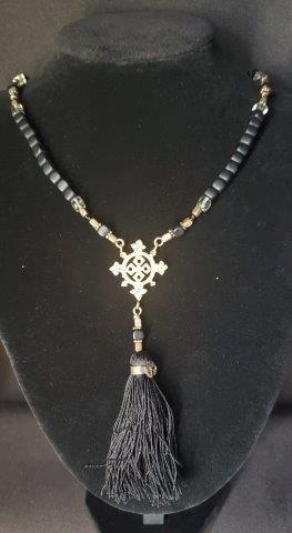 Intricate bead and tassel necklace: Intricate bead and tassel necklace with metal pendant