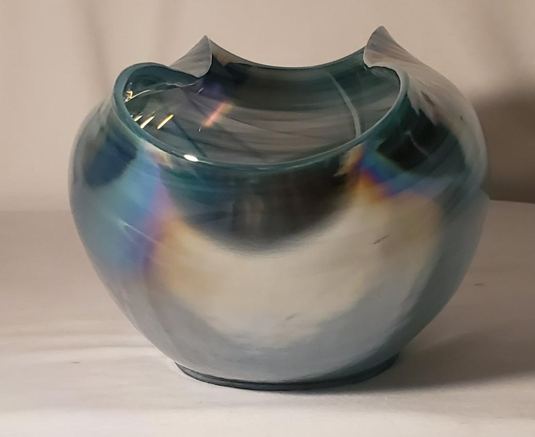 Blueish Greenish Clam Seashell Glass Bowl: 14" long and 6" tall with a clam seashell opening; emanating mystery of the deep seas and sporting rich luminous colors, this clam shaped centerpiece represents the unique artist imagination