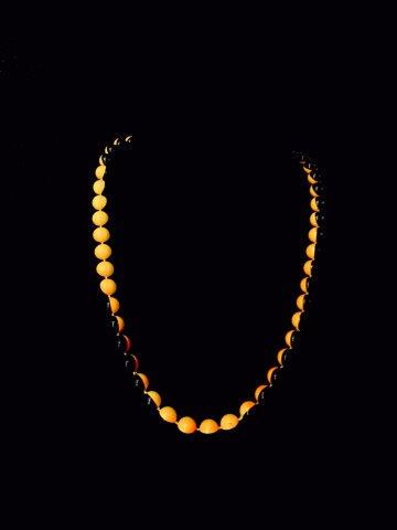 Vintage unique and rare black and yellow bead necklace: This vintage yellow and black bead necklace uniquely has half of the bead in yellow and the other in black. This 23 inch long unique piece is such a rare find.