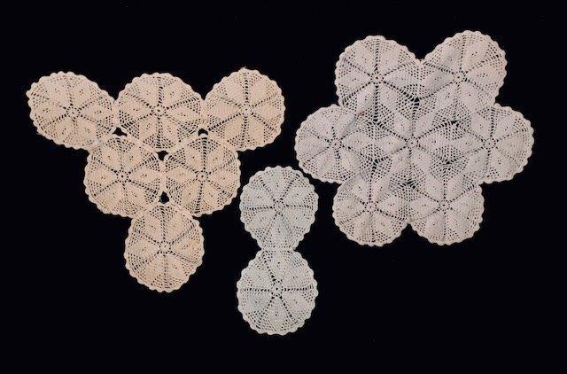 Trio Of Circular patterned Doilies: Vintage Crochet doilies with circular pattern. One white 11.5x5.5 inch, one round snowflake white has spot 16 inches in diameter. One triangular off white 15x17 inches
