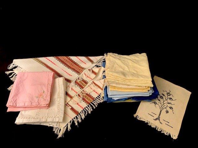 Assorted Linens 1: Grouping of assorted linens including, 14 yellow napkins, needle point tea towel, over a dozen blue napkins, 3 woven southwestern style tea twoels and more