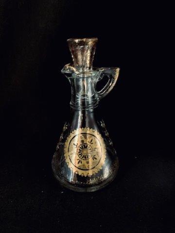 Mid Century ModernÂ Glass Oil Cruet: A nod to Georges Briard Style, 22KT gold trim (some fading).Â Includes stopper.Â Various Items sold AS IS.Â Some items may haver slight imperfections that are barely noticeable.Â Larger im
