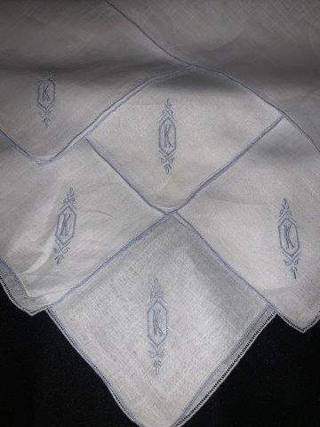Initial K monogrammed handkerchief set: Beautiful set of six matching monogrammed hanker chiefs with lovely border in bluish gray and matching initial K monogrammed 10 x 10 in size. See the next lot for an additional initial K item.