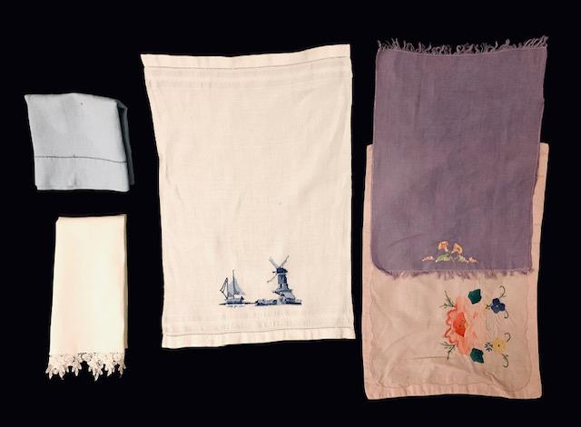 Grouping of vintage tea towels: Beautifully crafted group of 5 assorted tea towels, including a windmill scene needlepoint, embroidery, lace borders, and florals