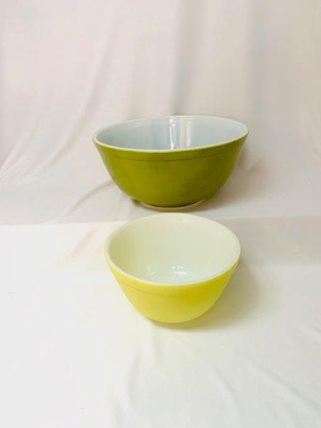 Two Vintage Pyrex Mixing Bowls: Pyrex primary color mixing bowls are a mid-century must. This lot includes one small yellow mixing bowl (401) and one medium mixing bowl (403) in green.
