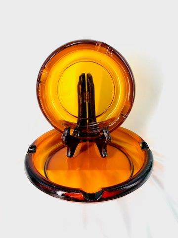 Dark Amber Glass Ashtray Pairing: Pair of super-cool Vintage matching nesting dark amber ashtrays, one 8 inches and the other 6 inches.