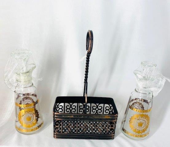 Georges Briard Style Oil Cruets with Caddy: Pair of 22 karat gold trim vintage oil cruets with caddy in the style of George Briard.