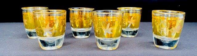 Six 22KT Gold Trimmed Shot Glasses: These six 22KT gold trim shot glasses are a great vintage find! Perfect condition with hardly any fitting to the 22 karat gold trim. Set of six standing at 2 inches tall.
