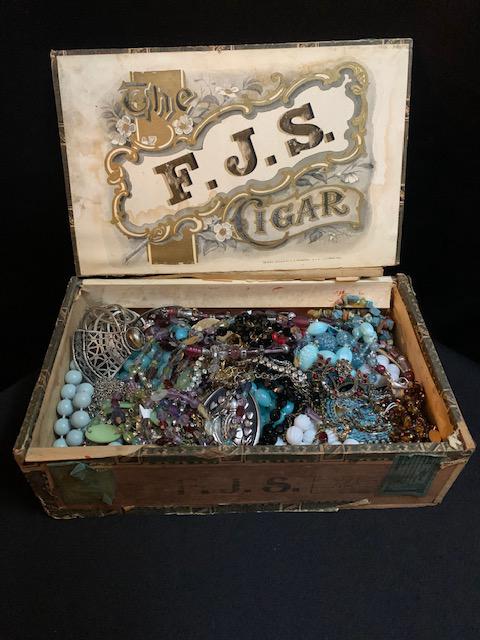 Cigar box full of costume jewelry: Cigar box full of costume jewelry Assorted styles colors and designs All items not inspected or tested