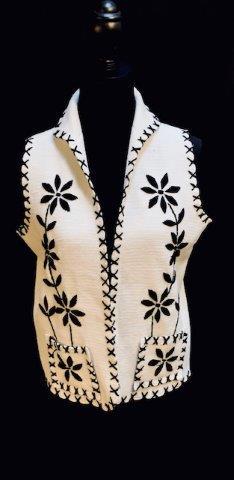 Vintage Sleeveless Sweater Vest: Vintage stitched sweater vest. This beautiful black and white sweater vest has unique large cross stitching for border trim and floral pattern.