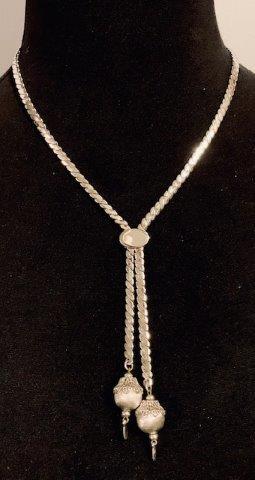 Vintage Silverstone Bolo Tie by Monet - Signed: Beautiful signed Monet 26-inch vintage silver Bolo tie. Adjustable in length. Loose on design of sliding oval cincher, and with clasp in back makes for easy fit. Detailed silver ball tastles at ends.