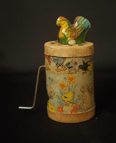 RARE!! 1930's American Lithographed Cardboard and: Here is a US made 1930's cackling chicken crank handle cylinder noise maker toy. Turn the handle and it makes a lusty cackle. The cylinder is covered in lithographed paper showing dressed duck family,