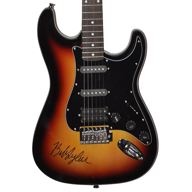 Signed Bob Dylan Guitar: This is a start styled guitar signed by Bob Dylan. This is a rare find as it is on a dark sunburst. This item comes with a third party COA and matching hologram stickers. This consigned item is from a