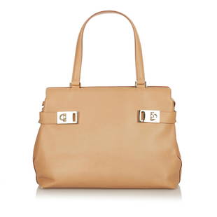 Salvatore Ferragamo Gancini Leather Tote Bag: Salvatore Ferragamo Gancini Leather Tote Bag Condition Quality: Fair Color: Brown Height: 8.5 in. Length: 12.75 in. Material: Calf Width: 4.5 in. Item Condition: Pre Owned 
