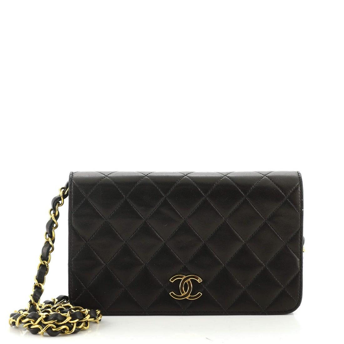 Chanel Vintage Full Flap Bag Quilted Lambskin Mini: Chanel Vintage Full Flap Bag Quilted Lambskin Mini Exterior Color: Black Interior Color: Red Exterior Material: Leather Interior Material: Leather Hardware Color: Gold Accessories: Dust bag