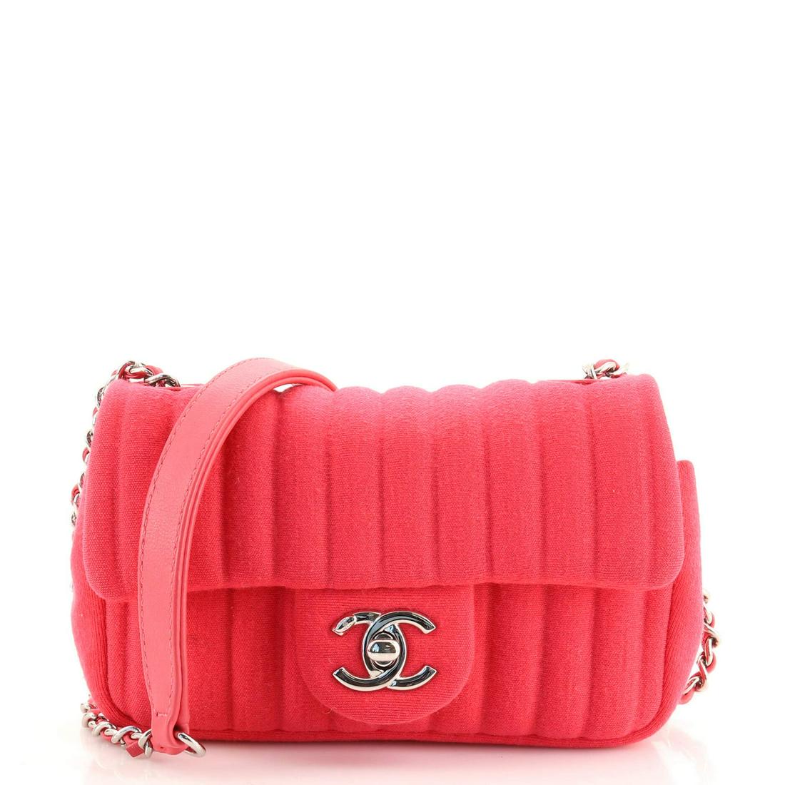 Chanel CC Charm Flap Bag Vertical Quilt Jersey Mini: Chanel CC Charm Flap Bag Vertical Quilt Jersey Mini Exterior Color: Pink Interior Color: Blue Exterior Material: Jersey Interior Material: Leather Hardware Color: Gold Tone Accessories: No accesso
