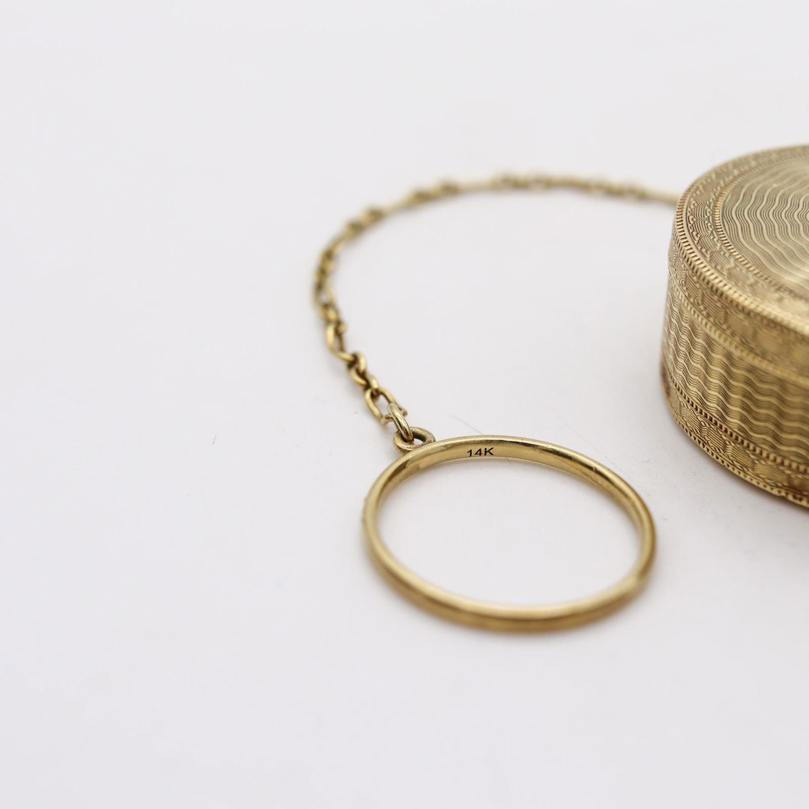 Tiffany & Co. 1910 Edwardian Guilloche Round Pill Box In 14Kt Yellow Gold: Tiffany & Co. 1910 Edwardian Guilloche Round Pill Box In 14Kt Yellow Gold Metal: Gold, 14k Gold, Yellow Gold Weight: 23.2 g Dimensions: Height: 0.59 in (14.99 mm) Diameter: 1.5 in (38.1 mm) Length: 4.