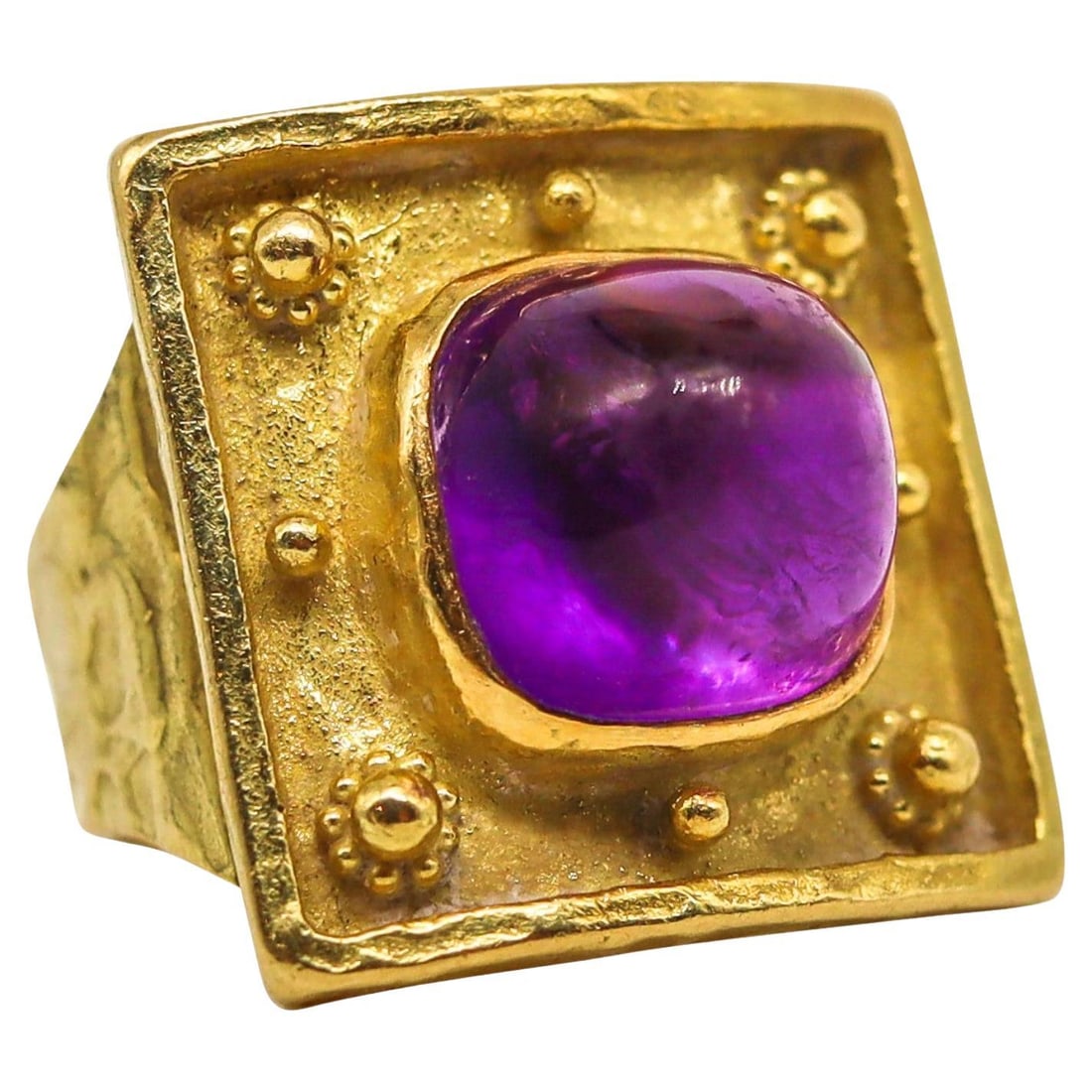 Ed Wiener 1970 Sculptural Cocktail Ring in 18Kt Yellow Gold with Vivid Amethyst: Ed Wiener 1970 Sculptural Cocktail Ring in 18Kt Yellow Gold with Vivid Amethyst Metal: 18k Gold, Yellow Gold Stone: Amethyst Stone Cut: Sugarloaf Cabochon Weight: 15.5 g Style: Modernist Period: 1