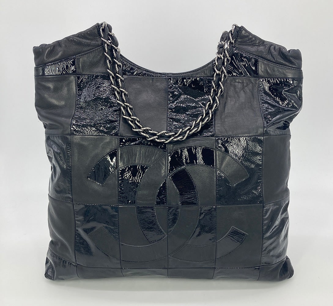 Chanel Black Leather Checkered Tote: Chanel Black Leather Checkered Tote Chanel Black Leather Checkered Tote in very good condition. Black lambskin and patent leather checkered exterior with CC logo along front side and double woven chai