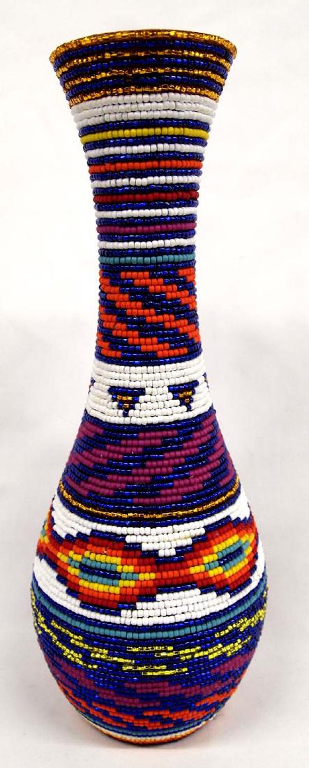 Kills Thunder Beaded Vase: Kills Thunder Beaded Vase. This wonderful piece stands 15 in High. Kathleen Kills Thunder was born in Seattle, Washington. Kathy has been painting and beading since she was six. She uses bright color 