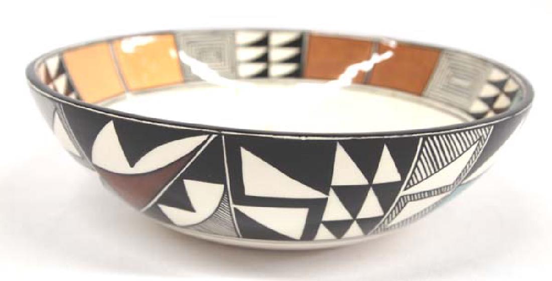 Kat'sima Ak'Hand Painted Ceramic Bowl: Hand Painted Ceramic Bowl Kat'sima Ak'uu, measures 7.5'' x 2.5''H and is signed by artist and with feather hallmark, Native American designs and highly glazed, very small nip in rim