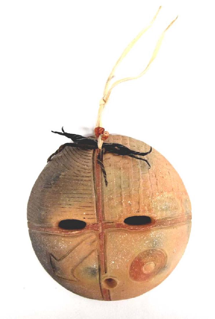 Taos Pueblo Pottery Mask by Fabiola Roybal-Calkins: 2009 Native American Taos Pueblo Pottery Mask by Fabiola Roybal-Calkins of Abiquiu, New Mexico, embellished with coral beads, ready to hang, signed by artist and measures 5.75''D