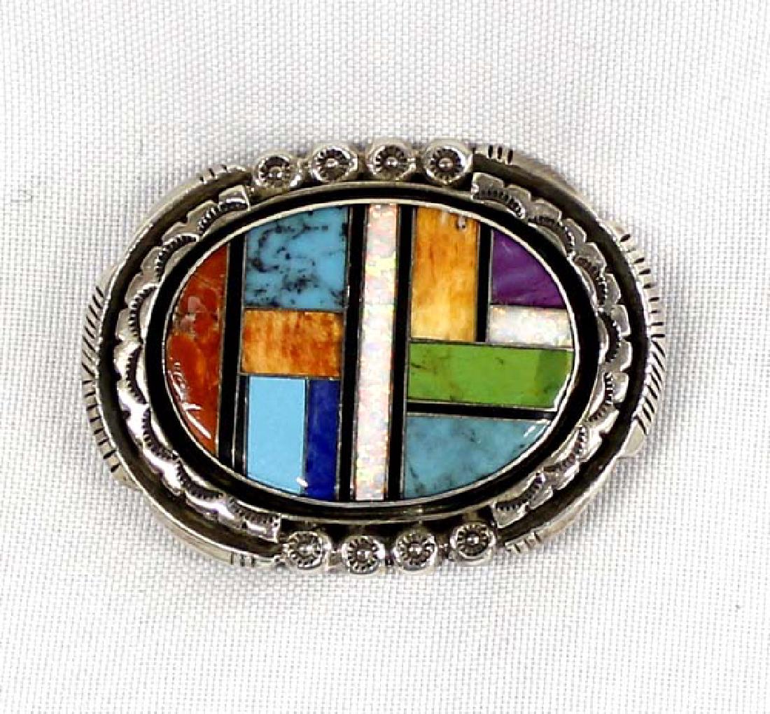Native American Navajo Sterling Silver Inlay Buckle: Native American Navajo Silver Inlay Buckle by Jackson Brown, stamped sterling and hallmarked, measures 2.25''L x 1.5''W, hand stamped details, includes red shell, opal, gaspeite, turquoise, sugilite,