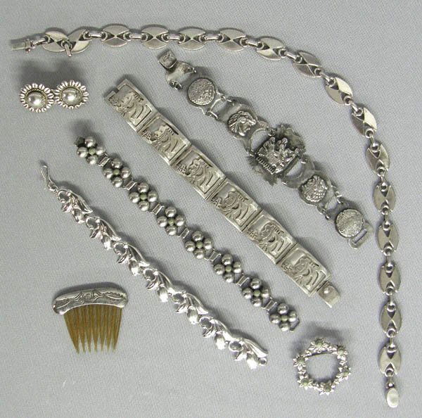 Collection of Mexican Silver Jewelry Qty 8: 8 Mexican Silver Jewelry Items. There are 4 silver link bracelets, a silver necklace, a hair clip and a round pin and a silver hair comb in this group. Some are marked Mexico. The bracelets are betwee