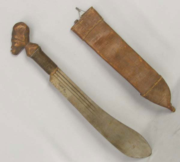 Vintage Trinidad Machete in Leather Sheath: Machete in Leather Sheath. On the blade of the machete, it is stamped, ''Robert Mole & Sons Birmingham England No. B335'' and there is a picture of a steamer ship. The hand is wood carved and brass wi