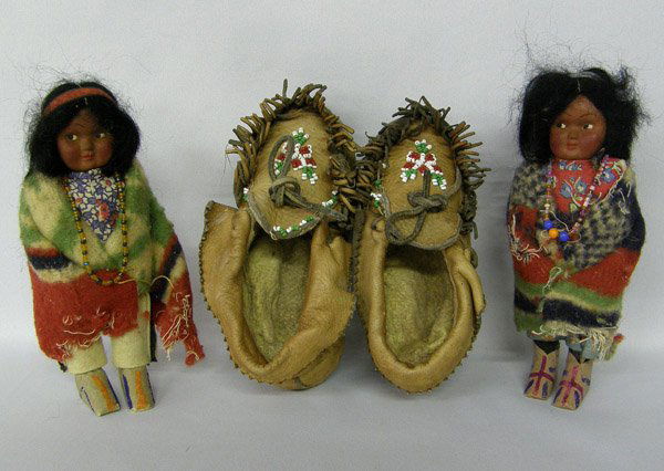 1 PR Children's Moccasins & 2 Skookum Dolls 6'': 1 PR Children's Moccasins & 2 Skookum Dolls 6''. SHI $20.