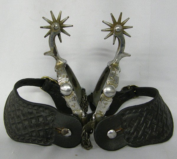 Pr Cowboy Vintage Western Spurs: Pair Of Vintage Western Spurs 10 x 4 inches. Has Tooled Leather Straps. SHI $20.