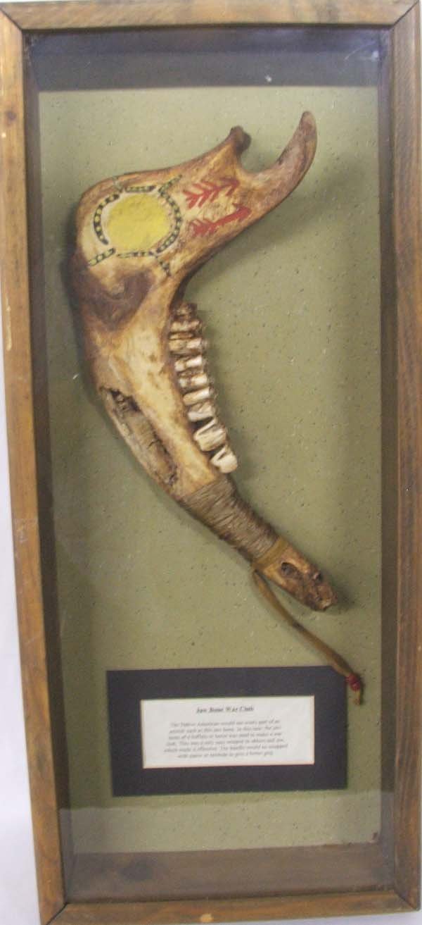 Jaw Bone War Club From Dances With Wolves: Jaw Bone War Club From Dances With Wolves, prop over run, with certificate of Authenticity. In wood case with glass front, some chipping on wood case. Measures approx. 24 3/4''L x 11''W x 2''H. SHI $7