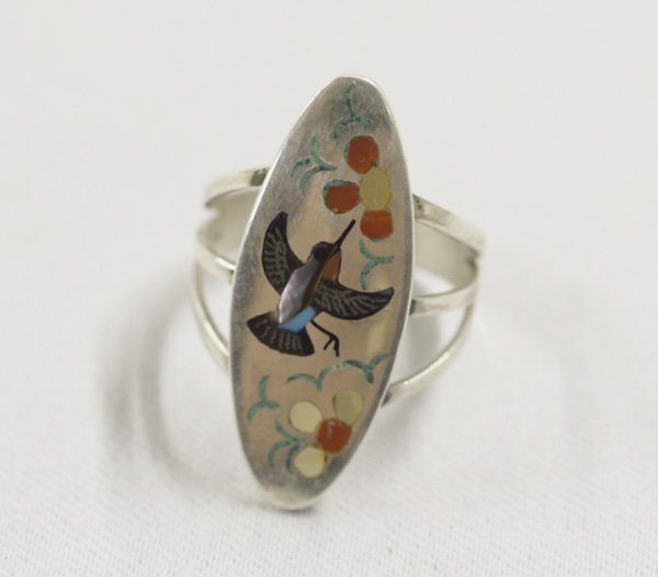 Zuni Inlay Hummingbird Ring by S&E Guardian: Zuni Inlay Hummingbird Ring by S&E Guardian, for Sammy & Esther Guardian. Hummingbird's body is Abalone, flowers are shell and coral inlay. Ring is a size 8.5 and measures 1.25 x .5". SHI $15