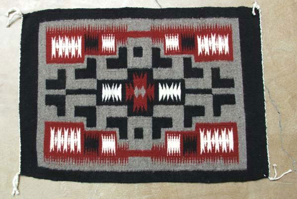 Navajo Storm Pattern Rug By Jessie Jim: Navajo Storm Pattern Rug By Jessie Jim, from Teec Nos Pos area. Measures approx. 23'' x 16''. SHI $20.