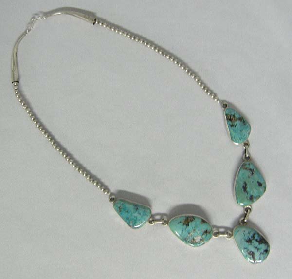 Navajo Turquoise Sterling Necklace By E. Begay: Navajo Turquoise Sterling Silver Necklace, sterling beads and cones, 5 natural Morenci Turquoise stones, Hallmarked Edison Begay. Necklace measures approx. 21'', pendant 1.25'' x .75''. SHI $15.