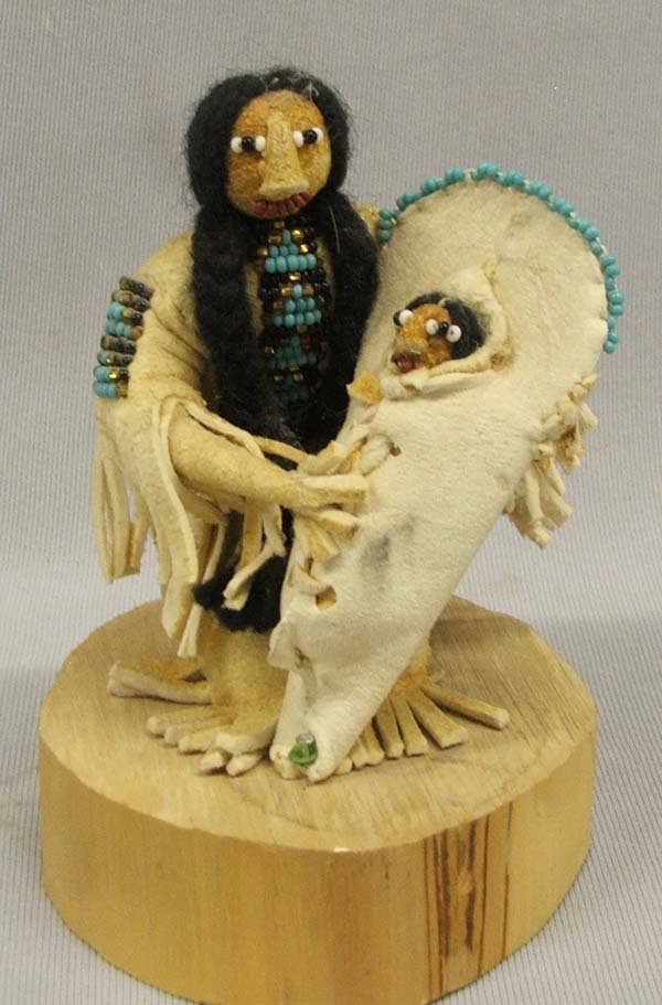 Apache Folk Art by Cecilia Ottogary: Apache Folk Art by Cecilia Ottogary. Leather Covered Mother and Cradle Board Baby on Wood Base. Measures 5''x4''. SHI $20.